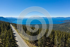 Aerial, drone view of Lake Tahoe in California surrounded by pine tree forests