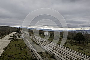 Aerial drone view landscape abandoned train station in Gascones sierra north of Madrid, Spain, in cloudy winter day