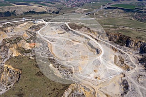 Aerial drone view of a limestone quarry, open pit mine