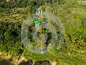 Aerial drone view of a lookout tower with green roof at a farmland in Jasin, Melaka, Malaysia