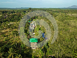 Aerial drone view of a lookout tower with green roof at a farmland in Jasin, Melaka, Malaysia