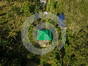 Aerial drone view of a lookout tower with green roof at a farmland in Jasin, Melaka, Malaysia