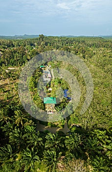 Aerial drone view of a lookout tower with green roof at a farmland in Jasin, Melaka, Malaysia