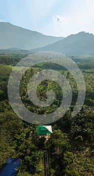 Aerial drone view of a lookout tower with green roof at a farmland in Jasin, Melaka, Malaysia