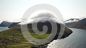Aerial drone view of Malinsfjall hidden in a fog, Faroe Islands.