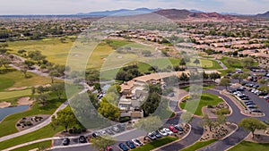 Aerial drone view of many cars parked near the Trilogy Golf Club