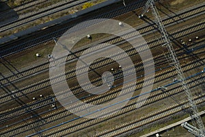 Aerial drone view on many lines of railway tracks on the groun in railway depot with blue compressed air pipelines, infrastructure