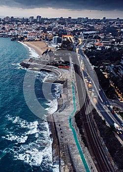 Aerial drone view of Marginal Avenue and coastline with looking west towards Cascais on a cloudy autumn day