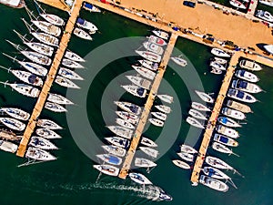 Aerial Drone View of Marina with Sailboats and Motor Boats Docked in Pier. photo