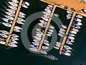 Aerial Drone View of Marina with Sailboats and Motor Boats Docked in Pier. photo