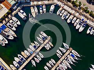 Aerial Drone View of Marina with Sailboats and Motor Boats Docked in Pier. photo