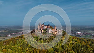 Aerial drone view of medieval Hohenzollern castle on top of hill in autumn, Baden-Wurttemberg, Germany