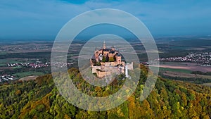 Aerial drone view of medieval Hohenzollern castle on top of hill in autumn, Baden-Wurttemberg, Germany