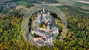 Aerial drone view of medieval Hohenzollern castle on top of hill in autumn, Baden-Wurttemberg, Germany