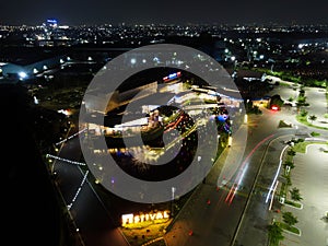 Aerial drone view of modern building in Jakarta central business district at night with Jakarta cityscape. JAKARTA. INDONESIA -