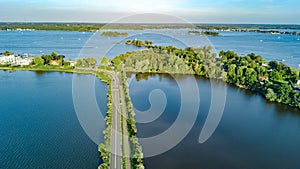 Aerial drone view of motorway road and cycling path on polder dam, cars traffic from above, Holland, Netherlands