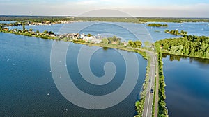 Aerial drone view of motorway road and cycling path on polder dam, cars traffic from above, Holland, Netherlands