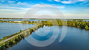 Aerial drone view of motorway road and cycling path on polder dam, cars traffic from above, Holland, Netherlands