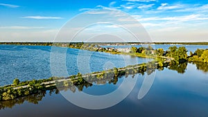 Aerial drone view of motorway road and cycling path on polder dam, cars traffic from above, North Holland, Netherlands