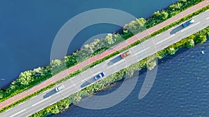 Aerial drone view of motorway road and cycling path on polder dam, cars traffic, North Holland, Netherlands