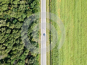 Aerial Drone View Of Moving Cars On Country Road With Forest And Agriculture Crop Field