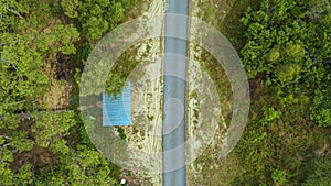Aerial drone view of a narrow paved road in village at Kampung Badong, Pekan, Pahang, Malaysia