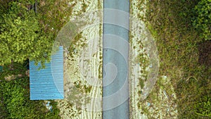 Aerial drone view of a narrow paved road in village at Kampung Badong, Pekan, Pahang, Malaysia