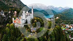 Aerial drone view Neuschwanstein castle on Alps background in vicinity of Munich, Bavaria, Germany, Europe. Autumn