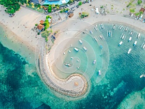 Aerial drone view of ocean, boats, beach, shore In Sanur Beach, Bali, Indonesia with with Traditional Balinese Fishing Boats