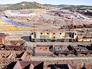 Aerial drone view of an old and rusty mining train used for transportation