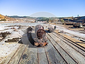 Aerial drone view of an old and rusty steam mining train used for transportation
