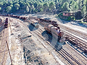 Aerial drone view of an old and rusty steam mining train used for transportation