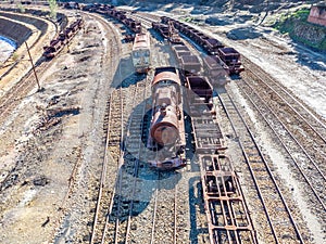 Aerial drone view of an old and rusty steam mining train used for transportation