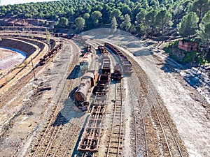 Aerial drone view of an old and rusty steam mining train used for transportation