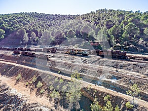 Aerial drone view of an old and rusty steam mining train used for transportation