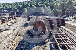 Aerial drone view of an old and rusty steam mining train used for transportation