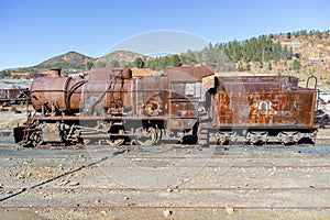 Aerial drone view of an old and rusty steam mining train used for transportation