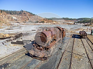 Aerial drone view of an old and rusty steam mining train used for transportation