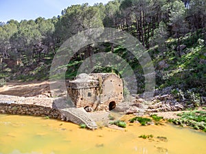 Aerial drone view of old watermill in the shore of Odiel river in the hiking route of the water mills along the