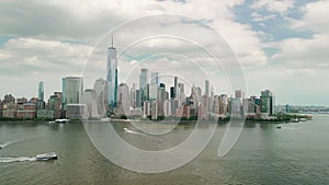 Aerial drone view over lower Manhattan. The drone orbiting the buildings in cloudy day