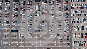 Aerial drone view of parking lot with many cars from above, city transportation