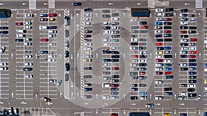 Aerial drone view of parking lot with many cars from above, city transportation