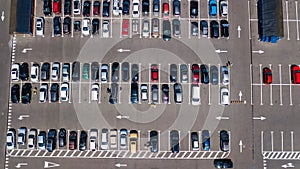 Aerial drone view of parking lot with many cars from above, city transportation