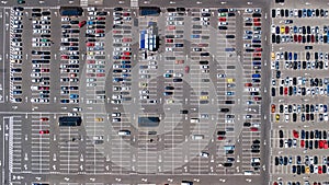 Aerial drone view of parking lot with many cars from above, city transportation