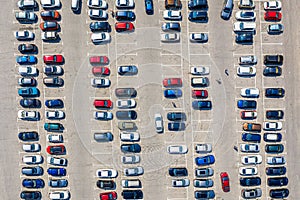 Aerial drone view of a parking lot with many cars near supermarket