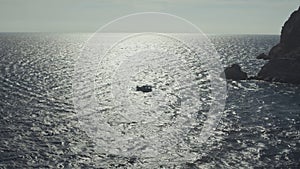 Aerial drone view of passenger small yacht cruising in popular Aegean sea. Shot. Slow motion effect, white ship floating