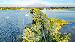 Aerial drone view of path on dam in polder water from above, landscape and nature of Netherlands