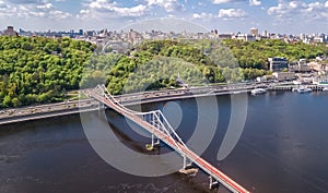 Aerial drone view of pedestrian Park bridge, Dnieper river and Kyiv cityscape, city of Kiev, Ukraine