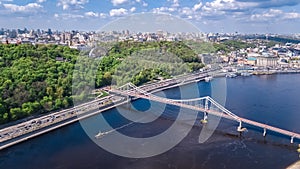 Aerial drone view of pedestrian Park bridge, Dnieper river and Kyiv cityscape, city of Kiev, Ukraine photo