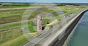 Aerial drone view of The Plompe Toren also called Plompetoren is a church tower on the Oosterschelde, a few kilometers